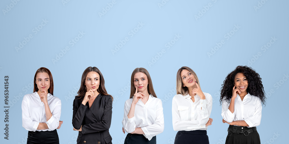 Smiling and pensive business people portraits in row, empty blue background Smiling and pensive business people portraits in row, empty blue background