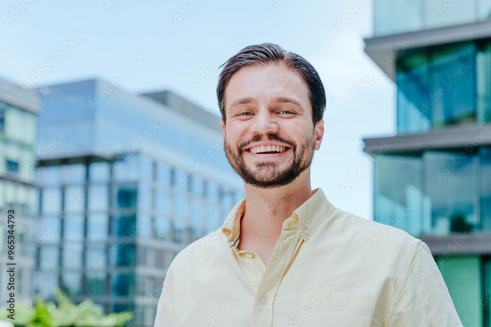 Smiling businessman with hair stubble near office building Smiling businessman with hair stubble near office building