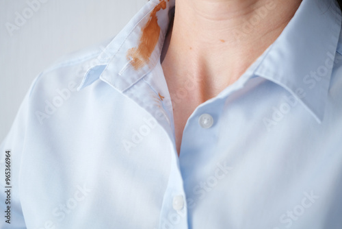 Close-up stained blue shirt collar a neutral background in a well-lit indoor space. everyday life stain concept. High quality photo