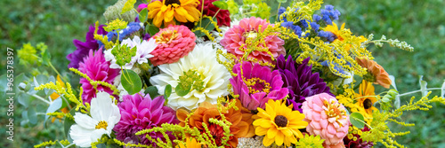 Summer bouquet. Beautiful multi colored fresh flower arrangement. Birthday weddding bouquet made of summer flowers photographed outdoors. photo