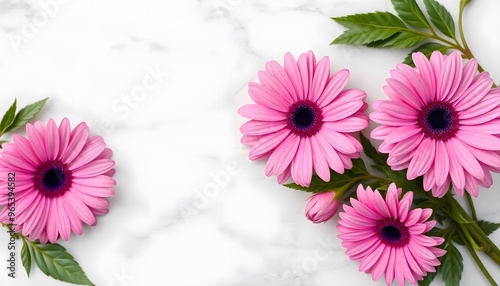 Bouquet of pink daisies with green leaves, arranged on a white marble surface.