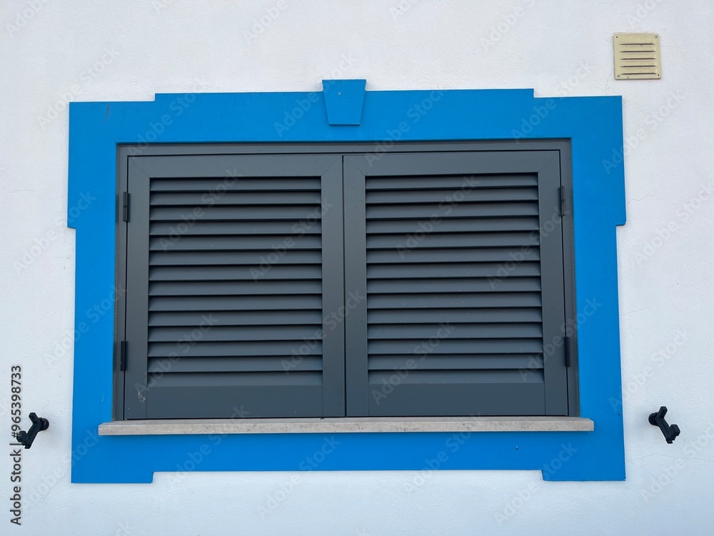 Dark shutters to protect from the sun, blue frame Dark shutters to protect from the sun, blue frame