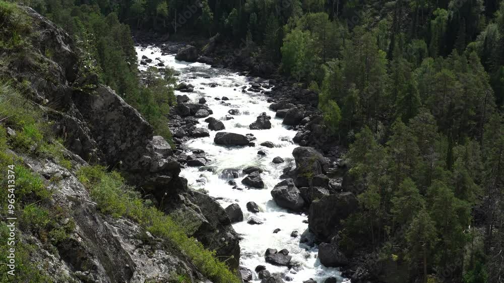Clear stream running through stone boulders Abundant river flowing on stone bottom. Wild mountain river water splashing in summer day bubbles. Beautiful View of Scenic Winding River Clear stream running through stone boulders Abundant river flowing on stone bottom. Wild mountain river water splashing in summer day bubbles. Beautiful View of Scenic Winding River