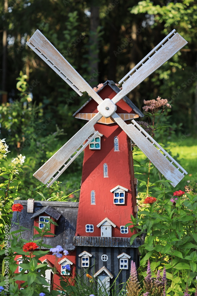 Ταπετσαρία A picturesque wooden windmill with a bright red roof situated in a lush green garden