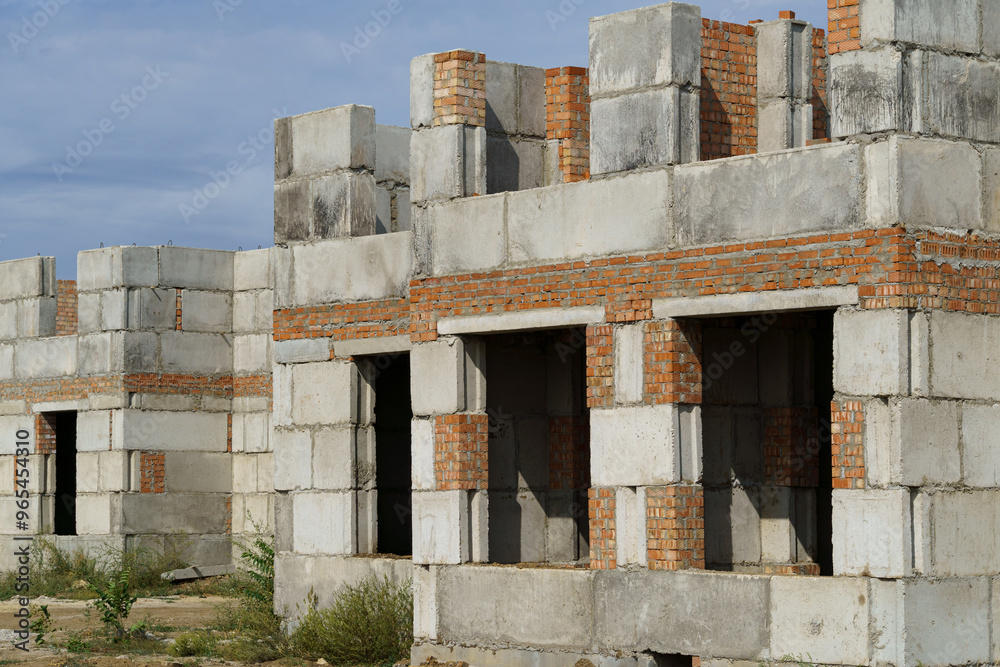 a construction site with a house under construction against the sky a construction site with a house under construction against the sky