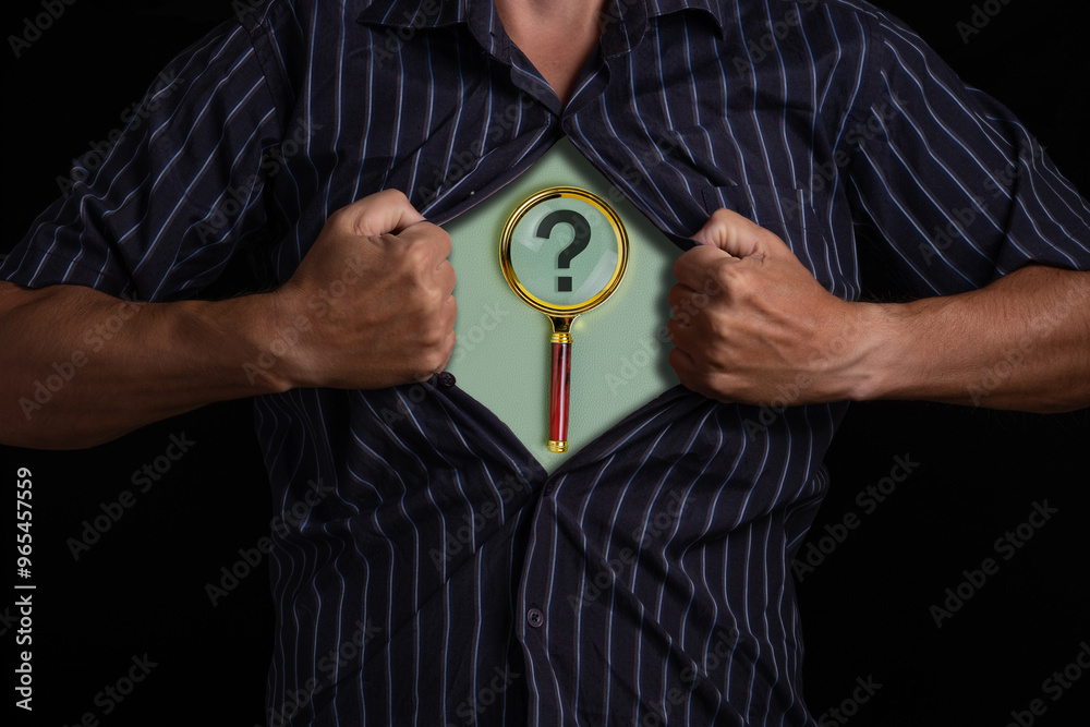 Man tears open his shirt, exposing magnifying glass with question mark, symbolizing unknown and search for answers.