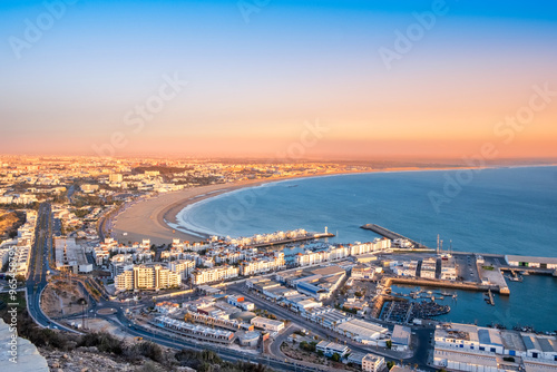 Agadir, Morocco at sunset. Panoramic view of Agadir city and bay in southern Morocco with Marina, beach and ocean from Oufla or Casbah fortress. Moroccan seaside resort on Atlantic coast in Africa
