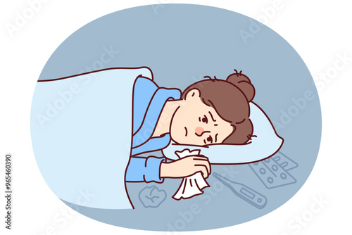 Woman sick with flu lies under blanket with handkerchief in hand near thermometer and medicines to treat fever. Sick girl needs qualified medical care due to outbreak of viral infection