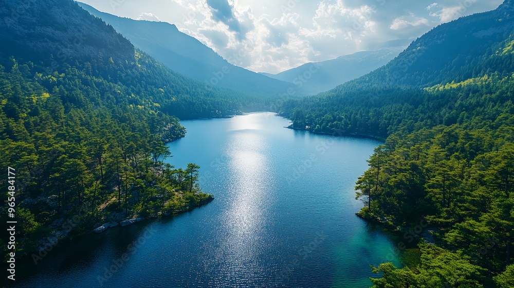 Obraz premium a lake surrounded by mountains and trees in the middle of the day