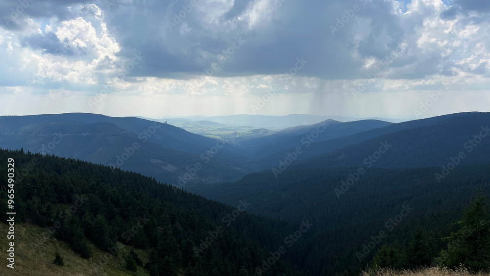 Rain clouds with rain over forested mountains. View from above. Sudeten Mountains. Czech Republic Rain clouds with rain over forested mountains. View from above. Sudeten Mountains. Czech Republic