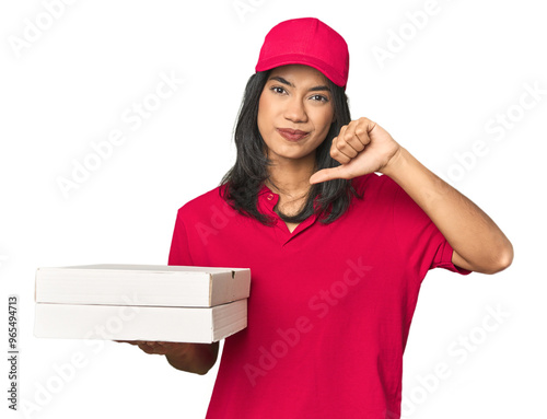 Latina delivering pizza, studio setup showing a dislike gesture, thumbs down. Disagreement concept. photo