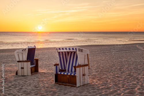 Fototapeta Naklejka Na Ścianę i Meble -  Hornum, Sylt - beach chairs at North Sea in sunset