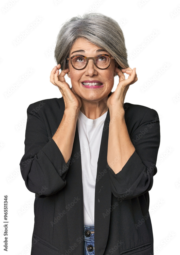 Caucasian mid-age female in business suit covering ears with hands. Caucasian mid-age female in business suit covering ears with hands.