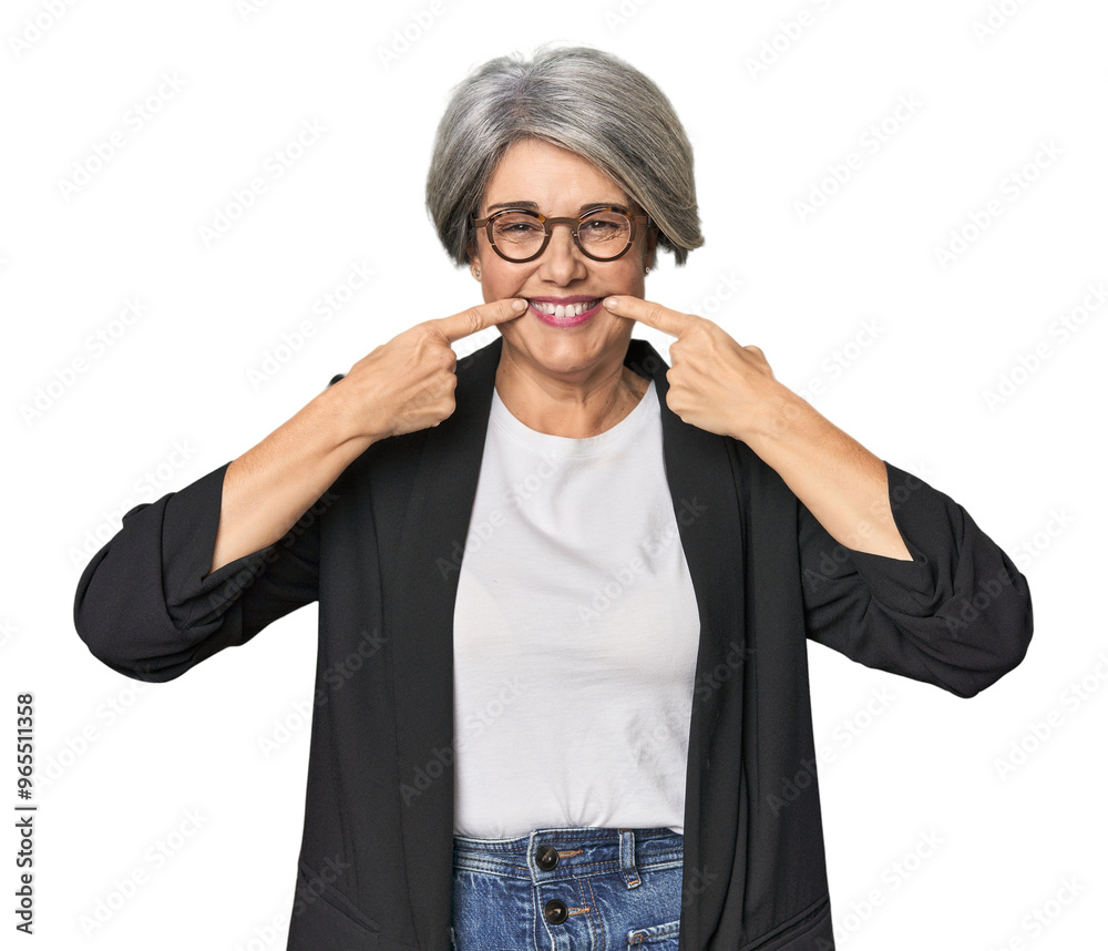 Caucasian mid-age female in business suit smiles, pointing fingers at mouth. Caucasian mid-age female in business suit smiles, pointing fingers at mouth.