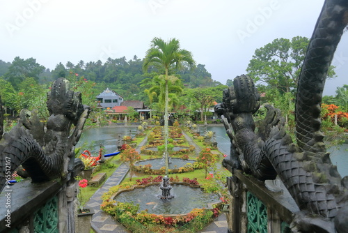 Bali in Indonesia - February 05 2024: people enjoy the Water Palace of Tirta Gangga in East Bali on a rainy day photo