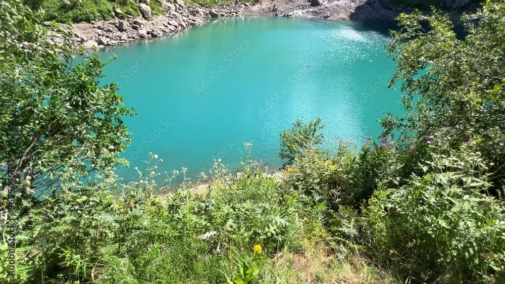 Lake Turye. A beautiful turquoise lake in the Dombay mountains, a summer hike through the national park to Alibek waterfall and glacier. Tourier Lake lake in the Caucasus mountains. Blue glacial water Lake Turye. A beautiful turquoise lake in the Dombay mountains, a summer hike through the national park to Alibek waterfall and glacier. Tourier Lake lake in the Caucasus mountains. Blue glacial water