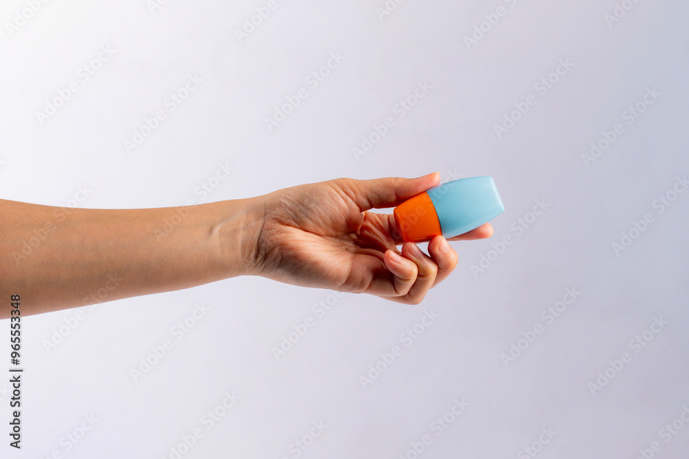 Blue cosmetic bottle, Skin care or sunscreen cosmetic in hand on white background. Blue cosmetic bottle, Skin care or sunscreen cosmetic in hand on white background.