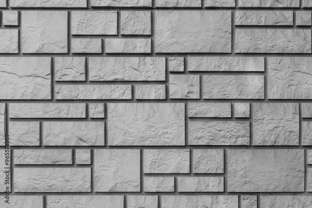 Black and white texture of a wall covered with decorative brick-like tiles. Abstract monochrome background for design. Black and white texture of a wall covered with decorative brick-like tiles. Abstract monochrome background for design.
