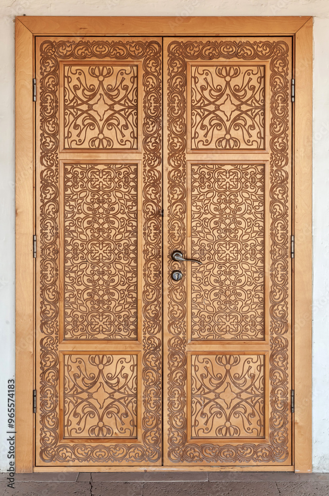 A carved wooden door from the walnut wood. A carved wooden door from the walnut wood.