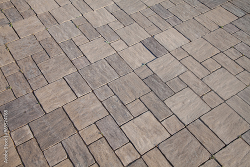 Close-up texture of beige stone background on pavement. Cement pavement