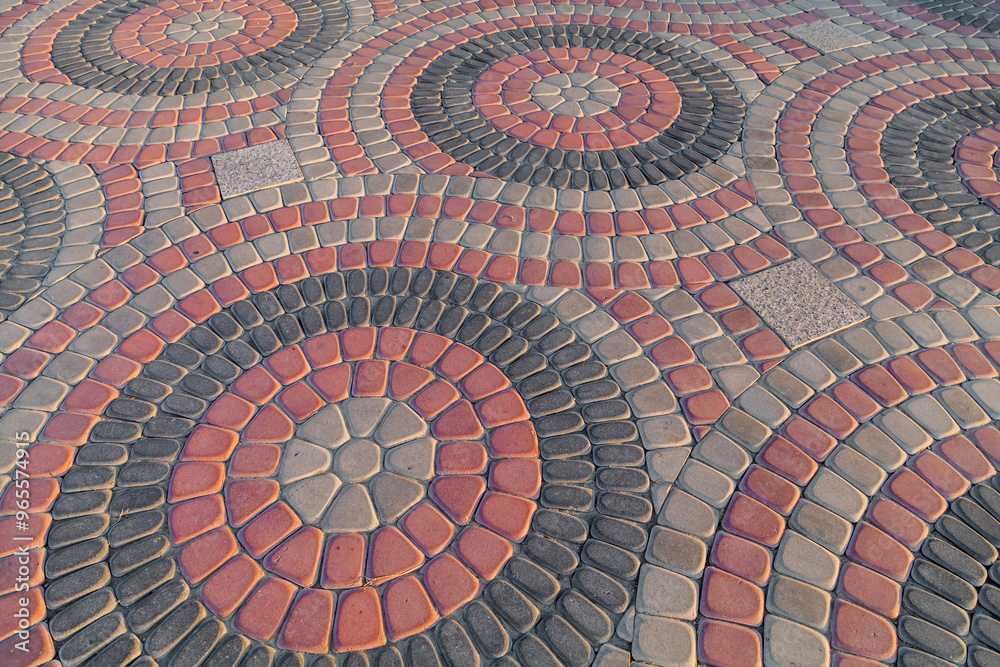 Round colorful pavement on sunny day in public park. Colorful paving stones in urban park landscaping design. Tile circles in garden Round colorful pavement on sunny day in public park. Colorful paving stones in urban park landscaping design. Tile circles in garden