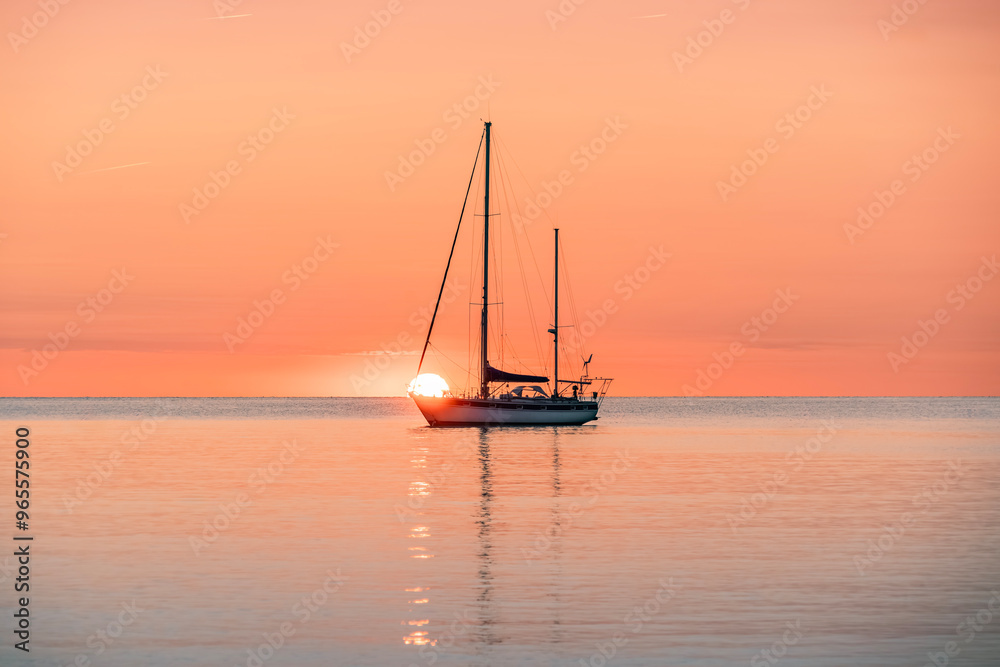 Silhouette Of A Pleasure Boat During A Beautiful Sunrise On The Waters Of The Mediterranean Sea In The Harbor Of The Coastal And Tourist Town Of Collioure (Cotlliure). France. Orange Sky. Silhouette Of A Pleasure Boat During A Beautiful Sunrise On The Waters Of The Mediterranean Sea In The Harbor Of The Coastal And Tourist Town Of Collioure (Cotlliure). France. Orange Sky.