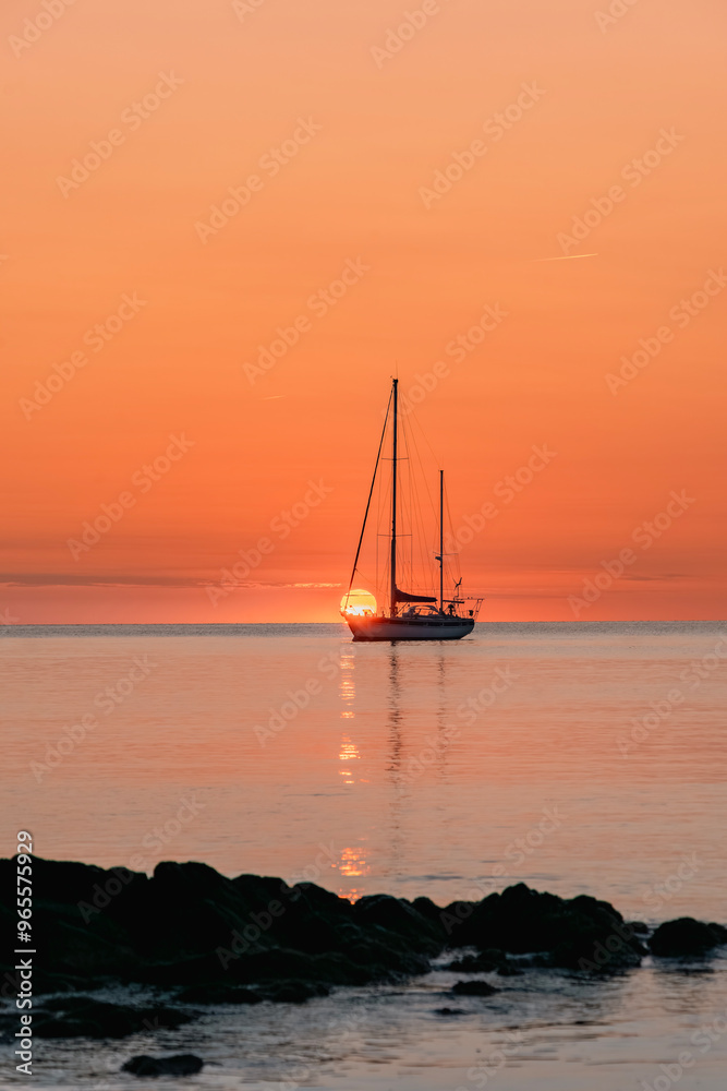 Silhouette Of A Pleasure Boat Moored In The Harbor Of The Coastal And Touristic Village Of Collioure (Cotlliure). France During A Beautiful Sunrise On The Waters Of The Mediterranean Sea. Orange Sky. Silhouette Of A Pleasure Boat Moored In The Harbor Of The Coastal And Touristic Village Of Collioure (Cotlliure). France During A Beautiful Sunrise On The Waters Of The Mediterranean Sea. Orange Sky.