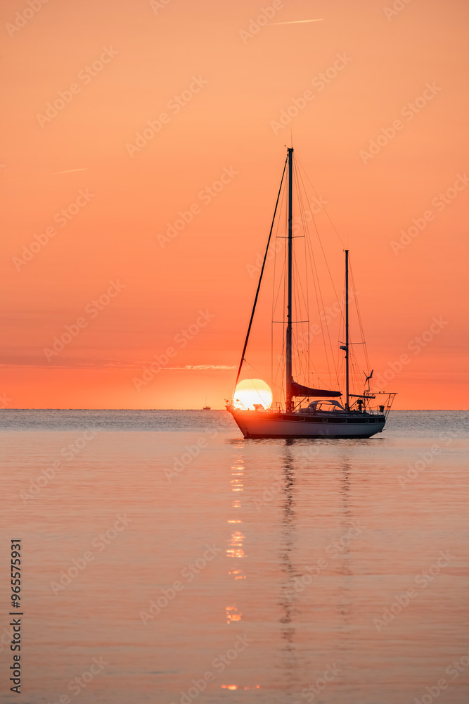 Silhouette Of A Pleasure Boat During A Beautiful Sunrise On The Waters Of The Mediterranean Sea In The Harbor Of The Coastal And Tourist Town Of Collioure (Cotlliure). France. Orange Sky. Silhouette Of A Pleasure Boat During A Beautiful Sunrise On The Waters Of The Mediterranean Sea In The Harbor Of The Coastal And Tourist Town Of Collioure (Cotlliure). France. Orange Sky.