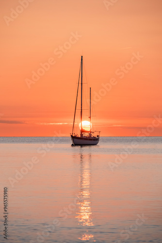 Silhouette Of A Pleasure Boat During A Beautiful Sunrise On The Waters Of The Mediterranean Sea In The Harbor Of The Coastal And Tourist Town Of Collioure (Cotlliure). France. Orange Sky.