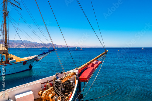 Pleasure yachts and sailboats anchored near stone pier in marina of the Red S...