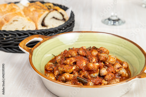 Bolinus brandaris or murici, Plate of seafood morsels with tomato sauce, boiled sea snails, Mediterranean Food in an elegant gourmet restaurant dish. photo