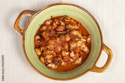 Bolinus brandaris or murici, Plate of seafood morsels with tomato sauce, boiled sea snails, Mediterranean Food in an elegant gourmet restaurant dish. photo