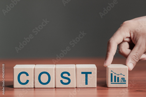 Cost reduction business finance concept, budget management and costs management. Optimization, strategy, economic cost savings. COST text on wooden blocks.