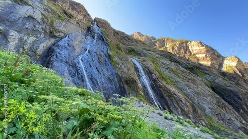 Sofrudzhinsky waterfall. Amanauz Gorge, Russia. A beautiful but difficult route to the largest waterfall of the Dombay valley. Caucasus, Dombai. Alibek River Gorge. Sufruju Glacier. 4K photo