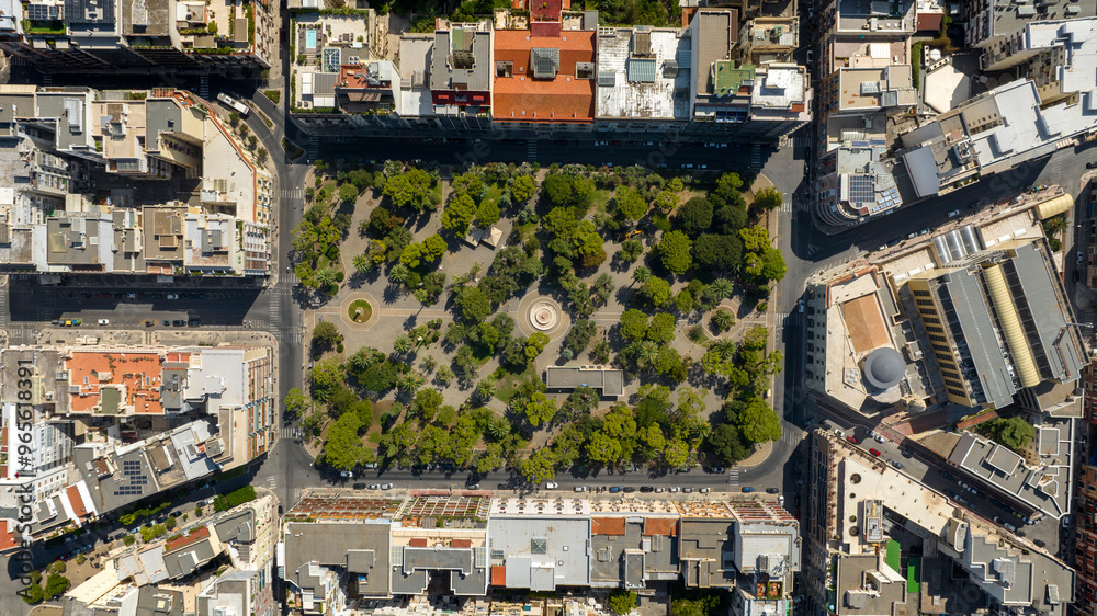 Fototapeta premium Zenithal aerial view of Garibaldi Gardens in Bari, Puglia, Italy. It is a large green area with a park and trees in the city.