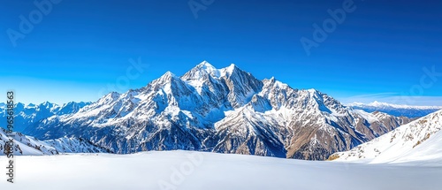 Snowcapped mountains under a clear blue sky, winter weather, cold and majestic