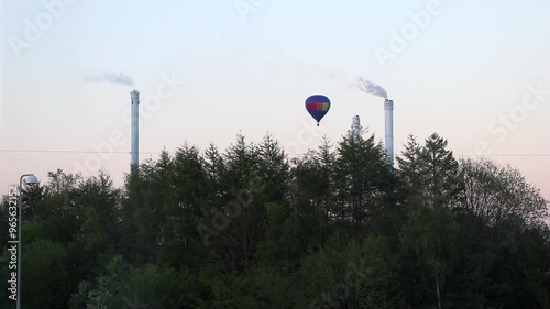 Hot air balloon between two chimneys