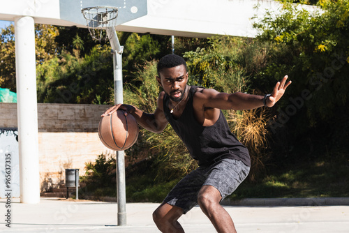 Fotografi Basketball street player dribbling with ball on the court - Streetball, basket b