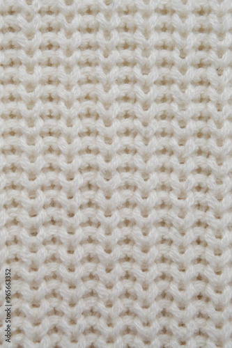 A close-up of the off-white wool sweater. Off-white textured background image.