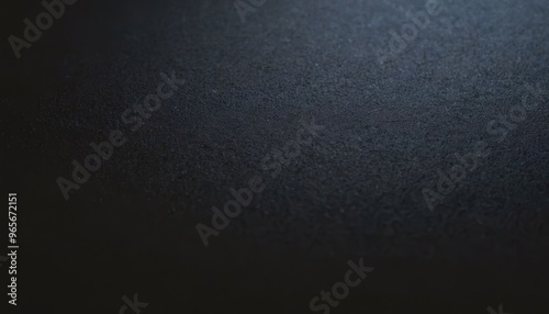 Close-up of a dark textured surface with a soft light source.