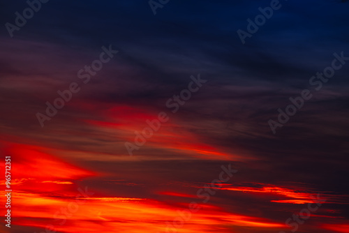 Background of the dawn sky with sunlight shining through the clouds creates a beautiful and fascinating color. 