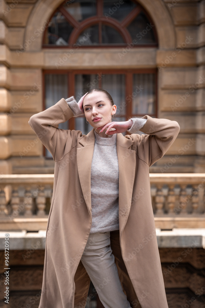Fototapeta premium Young beautiful woman wearing coat walking in the city centre of Prague, Europe