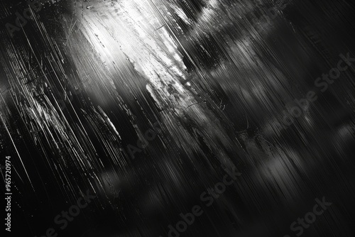 Abstract close-up of blurred black texture with streaks of light  creating a moody and atmospheric background.