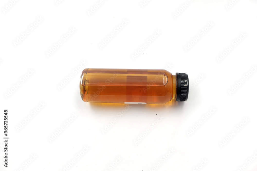 honey in a bottle, oil in a transparent bottle isolated on white background honey in a bottle, oil in a transparent bottle isolated on white background