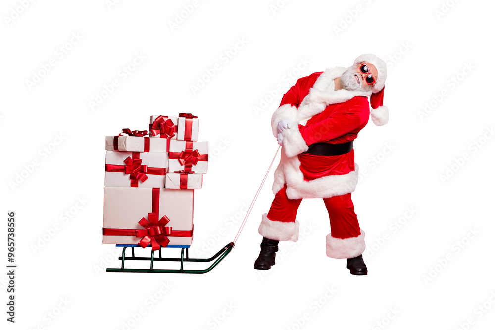 © deagreez - Fulll length photo of tired santa claus pulling his sledge with packages gifts on midnight wearing eyeglasses eyewear belt isolated over red background