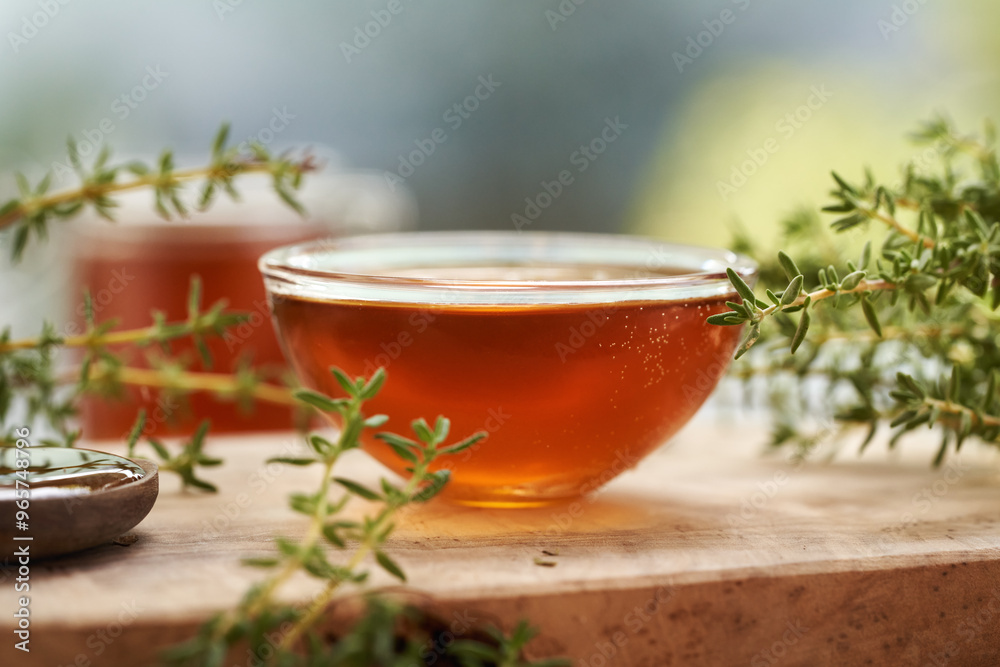 A bowl of homemade thyme syrup on a table A bowl of homemade thyme syrup on a table