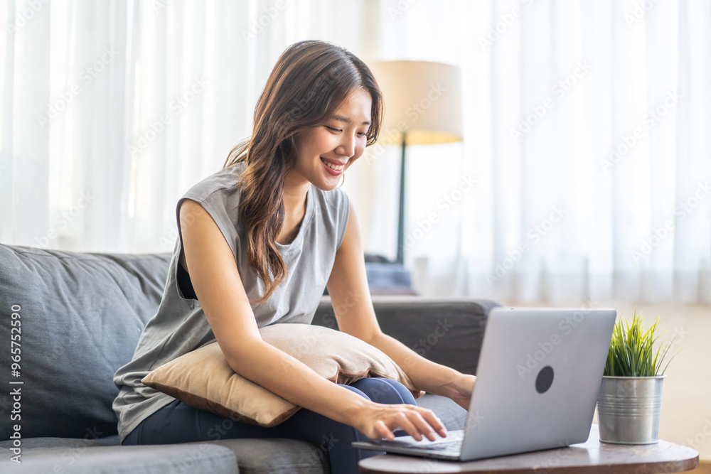 Young smiling asian woman happy relax use laptop conference work,learning, education, shopping, study online, webinar, online marketing, business, blog, digital internet advertising at home Young smiling asian woman happy relax use laptop conference work,learning, education, shopping, study online, webinar, online marketing, business, blog, digital internet advertising at home