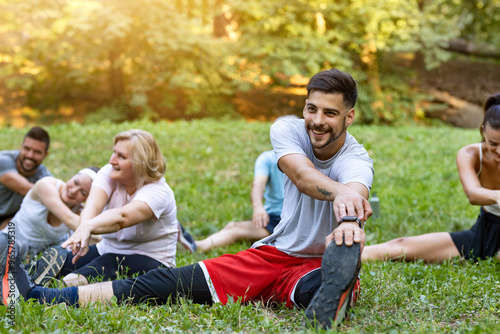 A group of people stretch after training 