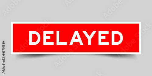 Red color square shape sticker label with word delayed on gray background