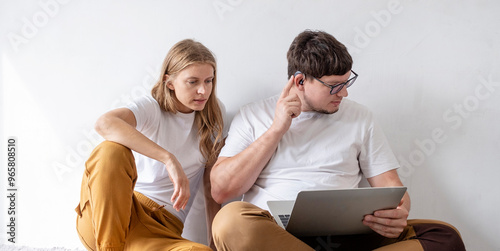 young woman and deaf man with audiology implant, having online call on laptop and gesturing